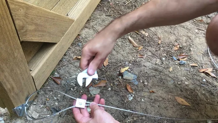 Tighten the bottom cable clamp.