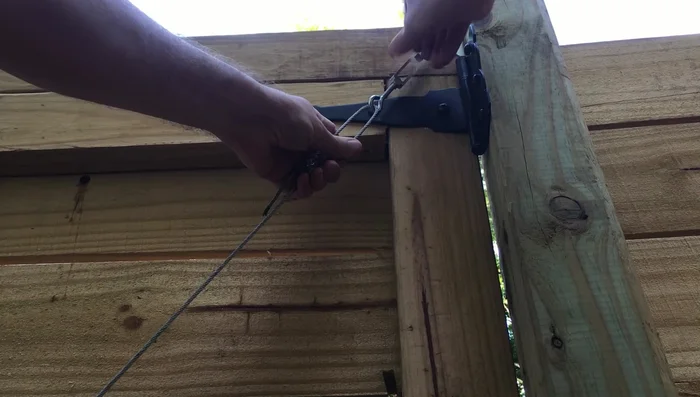 Tighten the turnbuckle to adjust the gate tension.