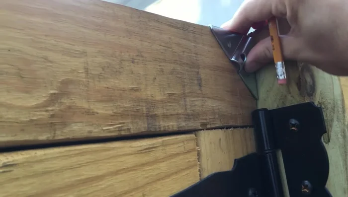 Attach the corner brackets to the gate posts.