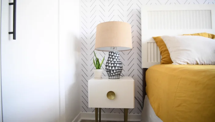 Style nightstand with lamp, plant, and accessories.