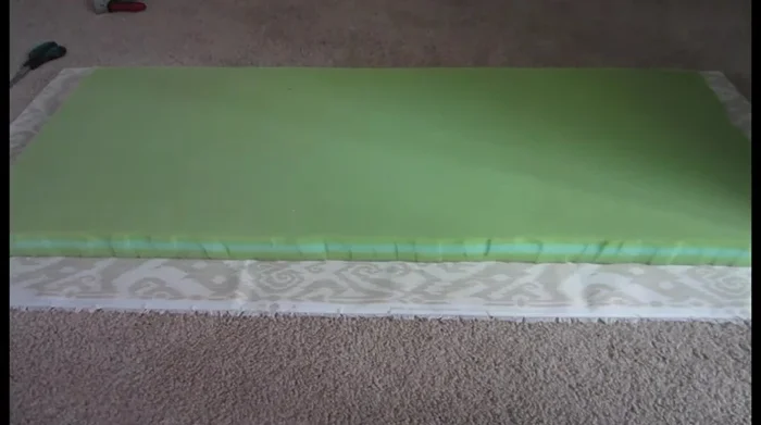 Secure the fabric to the underside of the coffee table. Start from the center and work your way outwards, ensuring the fabric is pulled tight. Use staples or pins to secure.