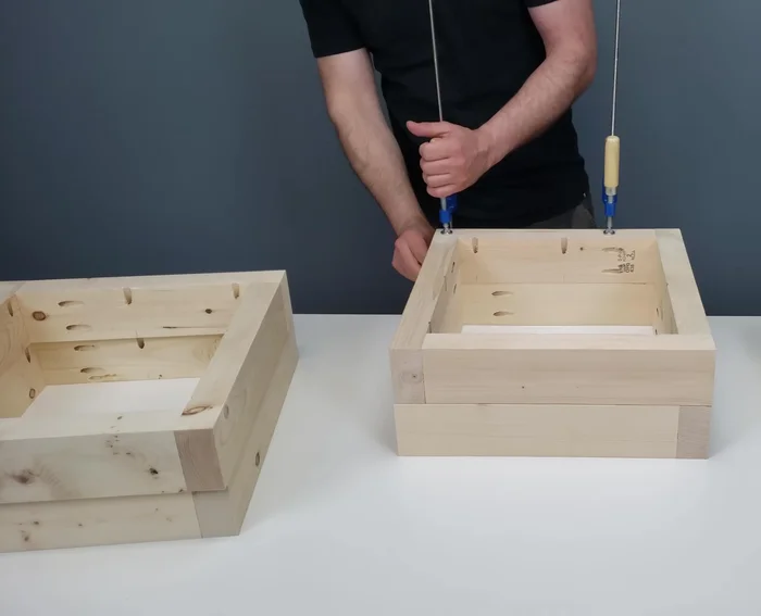 Attach the bottom pieces and use scrap wood shims to ensure proper alignment during screwing.