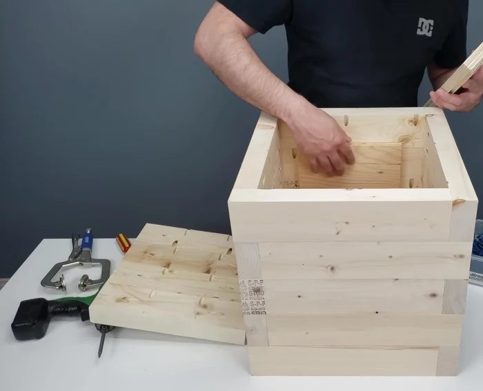 Attach the bottom pieces and use scrap wood shims to ensure proper alignment during screwing.