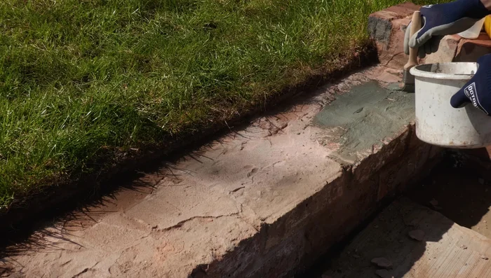 Apply SPR slurry to the existing brickwork or patio base, ensuring the surface is dampened beforehand for better adhesion. Then apply bedding mortar.