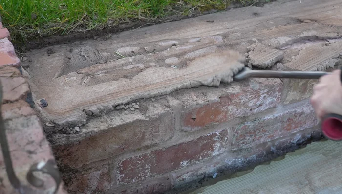 Remove damaged patio slabs using an SDS drill with chisel action.