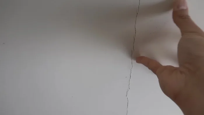 Clean the crack: Remove any loose material from the crack using a scraper.
