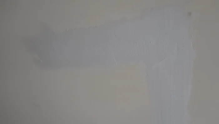 Scrape and sand the first coat: Remove any high spots with a scraper and lightly sand the edges if necessary.