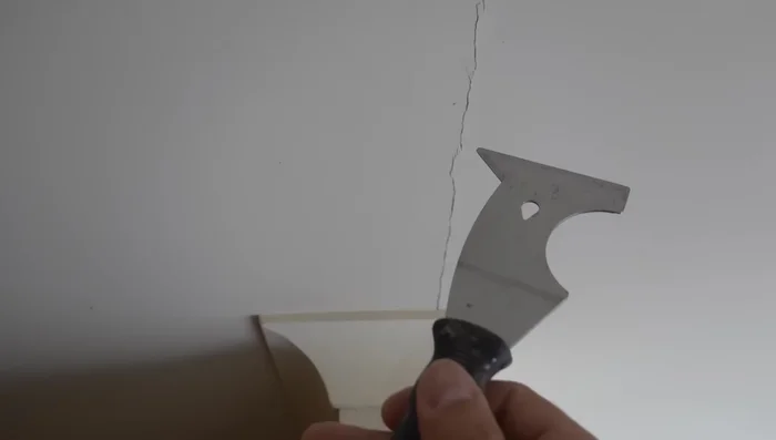 Clean the crack: Remove any loose material from the crack using a scraper.