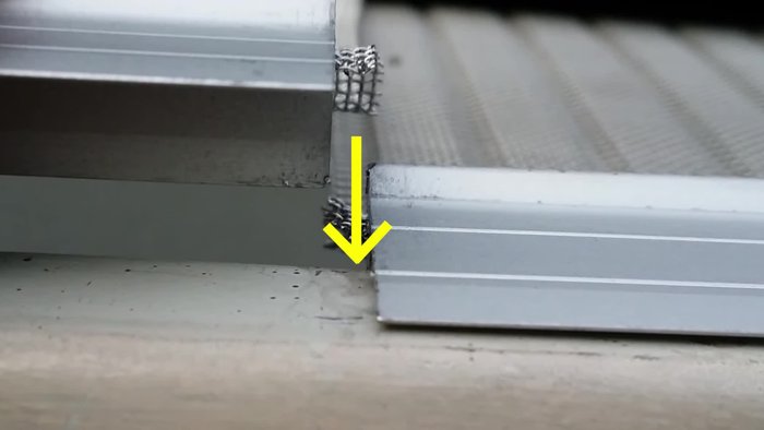 Fasten three self-tapping screws for each 4' section using the line guide on the aluminum extrusion as a reference. The screw's drill bit will go through the aluminum and gutter.