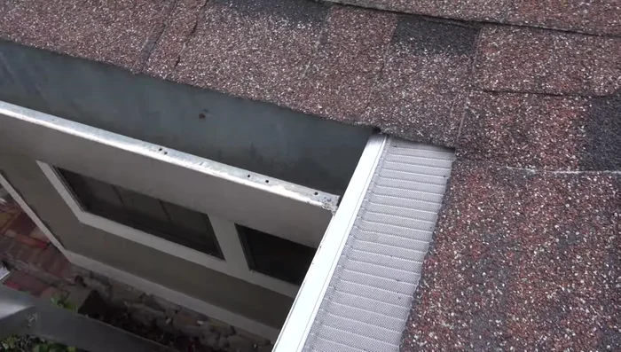 For inside corners, slide a section flush to the back corner. Cut the adjoining piece the same way as the endcap, cutting both aluminum strips back about an inch so the mesh covers the gap.