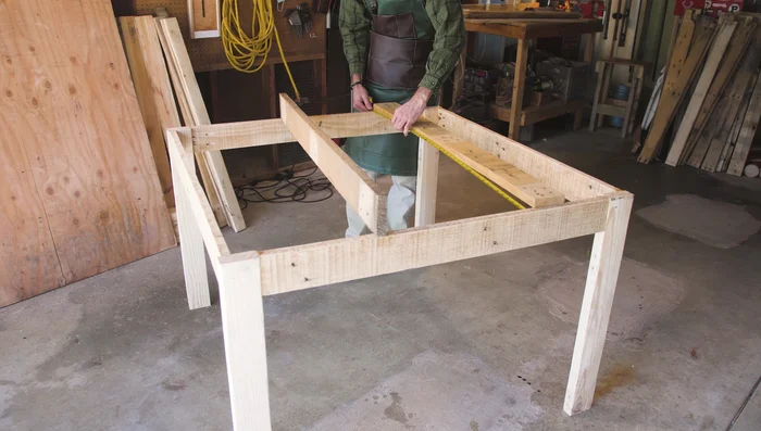 Add support beams to the underside of the table top to prevent sagging.