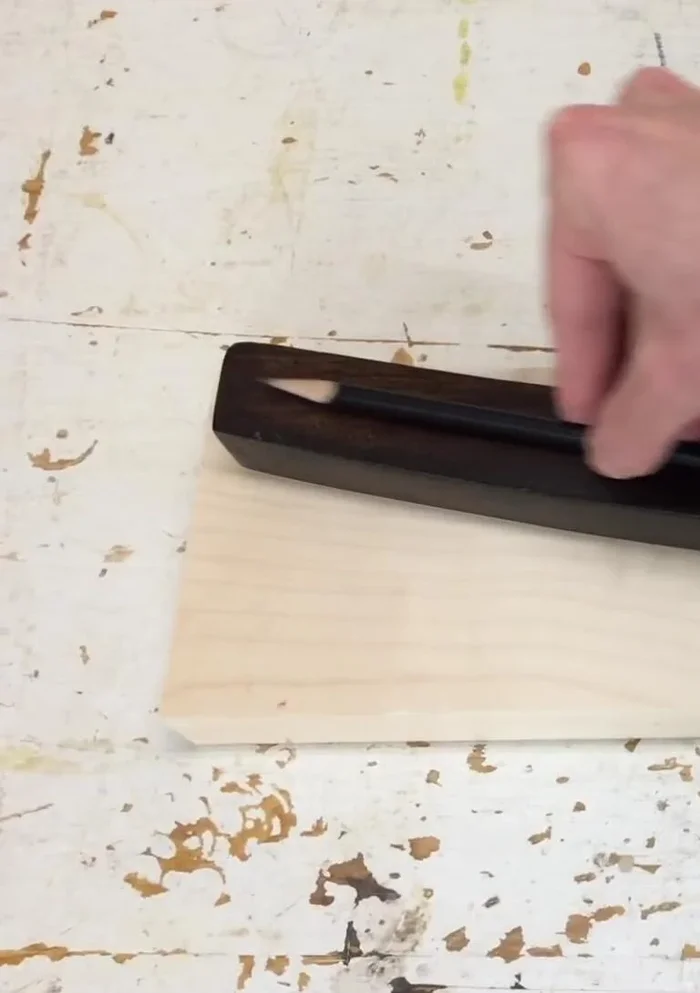 Sand the new leg section to match the existing piece in both appearance and feel.