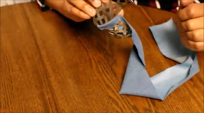 Apply glue to secure the overlapping edges and inner fold.