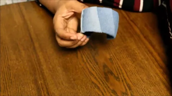 Reinforce the cord by placing a small piece of denim over it to secure it while the glue dries.