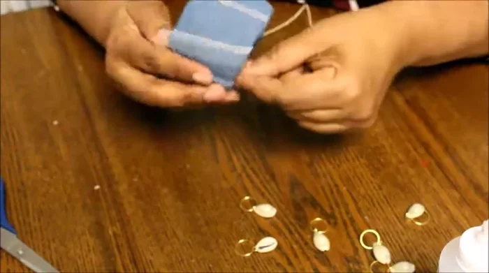 Reinforce the cord by placing a small piece of denim over it to secure it while the glue dries.