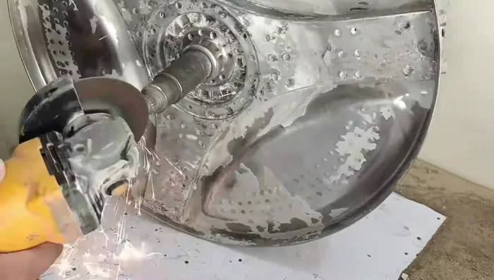 Use an angle grinder to flatten the expanded shaft of the drum.