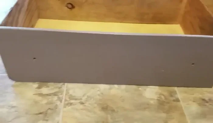 Sand the drawer surface to smooth it out.