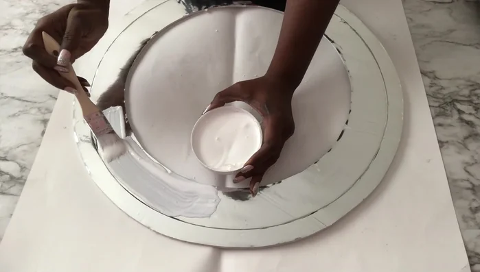 Create the clock face: Cover the inner side of a foam board cutout (or a similar shape) with Mod Podge, sprinkle Kirsch, and seal with another layer of Mod Podge.