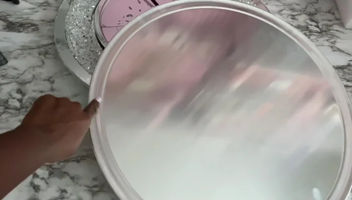 Create Roman numerals (Method 1): Use flexible mirror sheets or mirror reflective paper on poster board to cut out Roman numerals and glue them onto the clock.