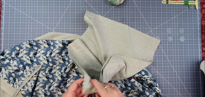Create triangular ends: Fold the seam allowances of one end to the inside. Press flat. Repeat for the other end.
