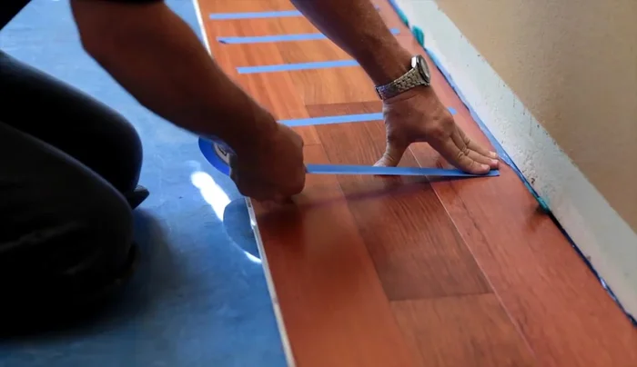 Cut and install the last row, maintaining expansion gaps. Use a pry bar to snug the floor tightly.