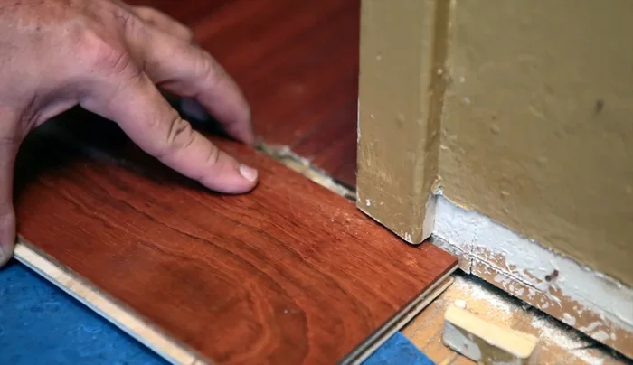 Remove loose debris and any stubborn pieces of wood from the floor.