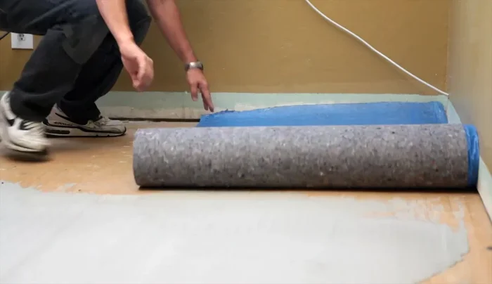 Unroll underlayment and trim off excess.