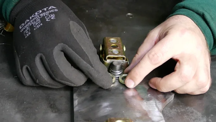 Weld half a nut to each side of the head as ears.