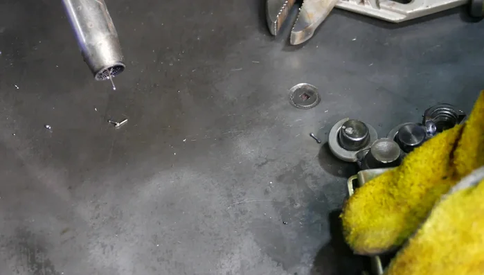 Weld half a nut to each side of the head as ears.