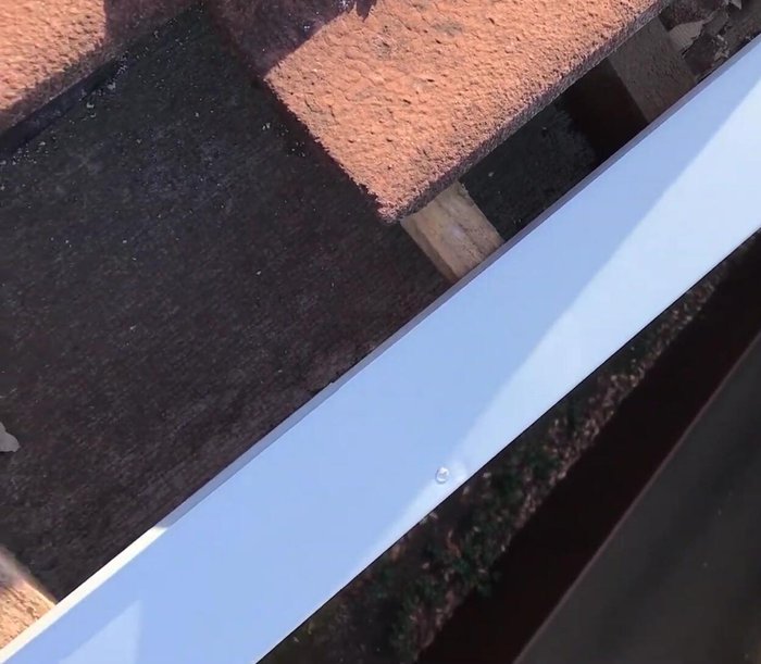 Install galvanized flashing on top of the barge board to create a channel for water runoff.