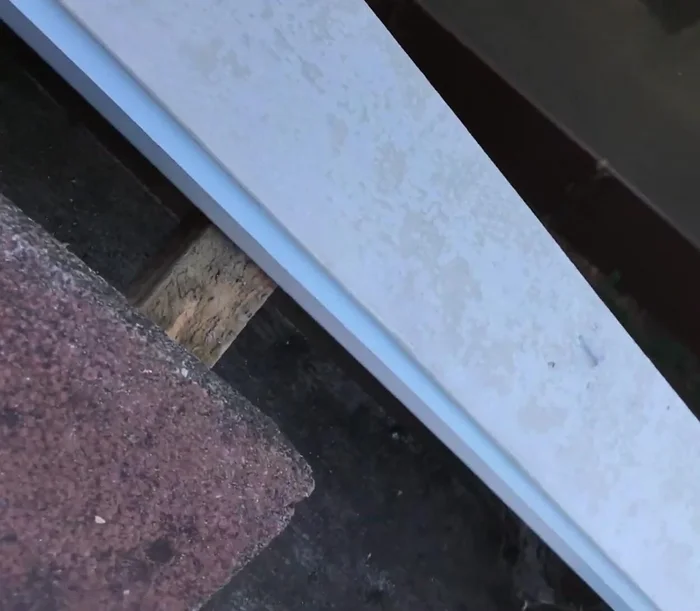 Tidy up the edge of the existing tiles to create a smooth surface for the new pointing. Use a grinder to cut excess tile if needed.