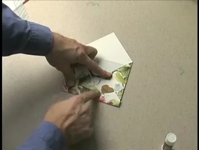 Fold the paper along the crease lines created by the template. Create a sharp crease from top to bottom.