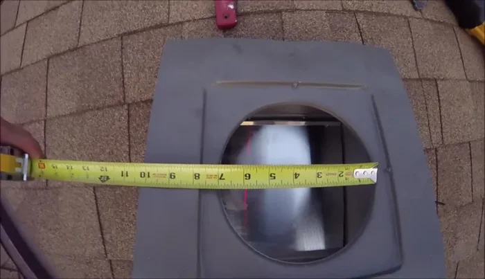 Measure the hole in the bottom of the vent (approximately 7 inches) and cut a slightly larger hole on the roof using a reciprocating saw or jigsaw.