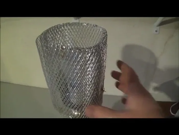 Create the lampshade: Wrap the gutter guard around the bulb area and secure it with string or twine.