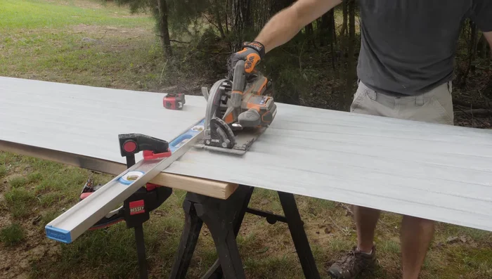 Attach corrugated metal panels to the frame using appropriate screws.