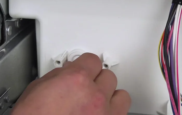 Remove the float arm by pulling it straight out.