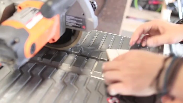 Cut tiles around outlets, stopping at the drywall.