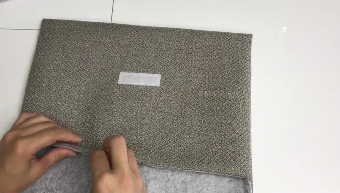 Add optional fabric or leather piece for a label or pull tab.