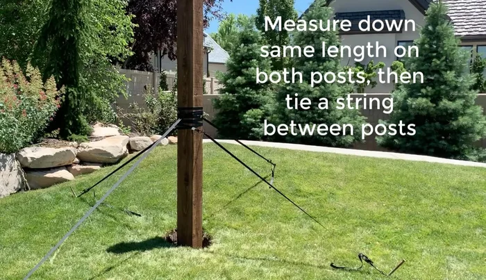 Measure and level the second post to match the first post's height. Ensure the distance between the inside of the posts is 14 feet 2 inches.