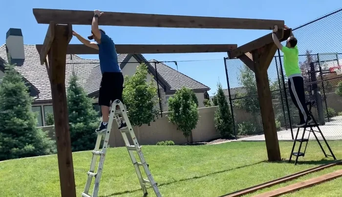 Install the long supports, spacing them evenly and attaching with metal brackets.