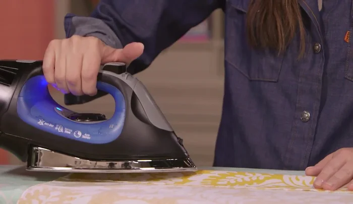 Hem long sides: Fold up 3 inches on each long side, press, and pin.