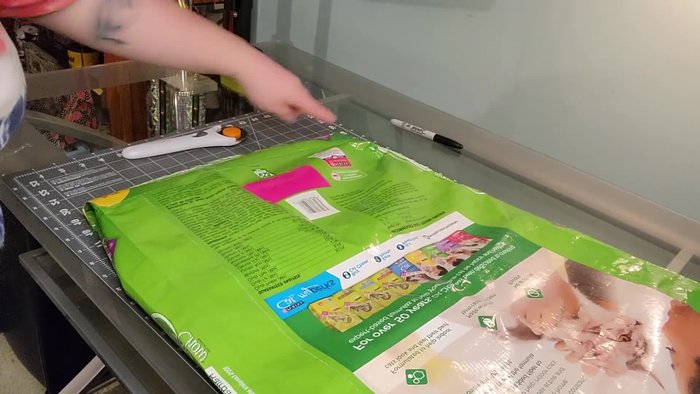 Flatten the bag and cut off the bottom seam to open the bag.