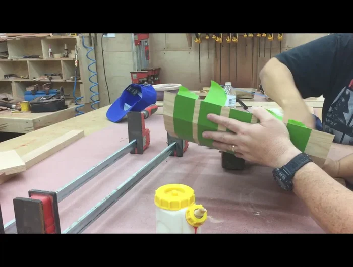 Clamp the lid loosely, ensuring it will fit the box, and add weight for even glue pressure.