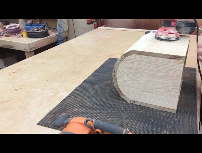 Sand the box, starting with a belt sander, then a random orbit sander, finishing with 220-grit sandpaper.