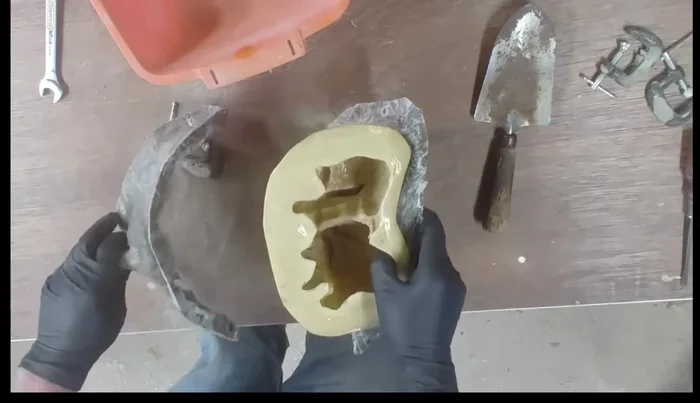 Place the mold inside a fiberglass shell to maintain its shape during cement pouring. Secure it using clamps, bolts, or tie wraps.