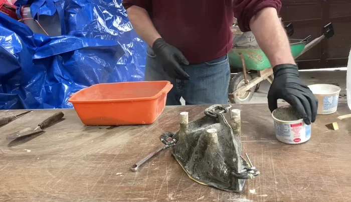 Slowly add water to the cement-sand mixture, ensuring it’s loose enough to pour but not too watery. Aim for a consistency similar to soft-serve ice cream.