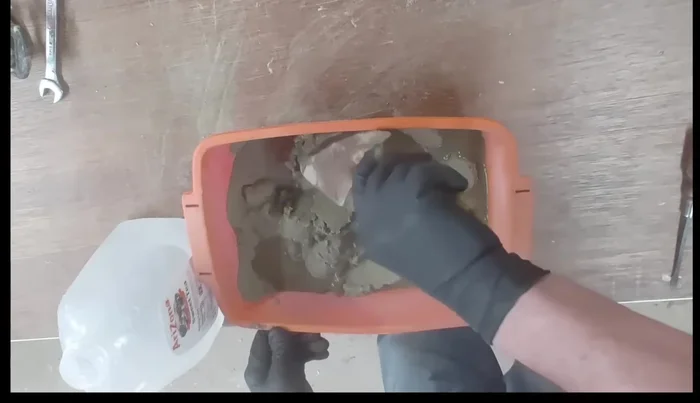 Slowly add water to the cement-sand mixture, ensuring it’s loose enough to pour but not too watery. Aim for a consistency similar to soft-serve ice cream.