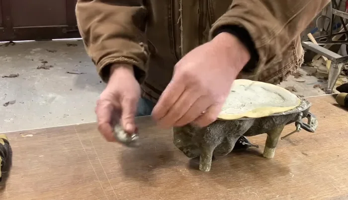 Once the cement has set, carefully remove the figure from the mold by gently working your way around the edges. Latex molds are particularly easy to remove from.