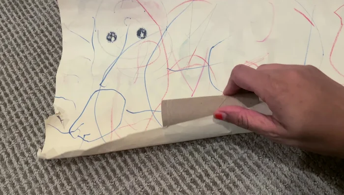 Install tension curtain rods and attach a roll of drawing paper for a built-in drawing surface. Use an empty toilet paper roll to create a clean edge for the paper roll.