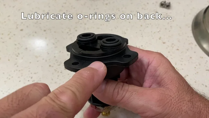 Place the plastic adapter and re-secure with the screws.